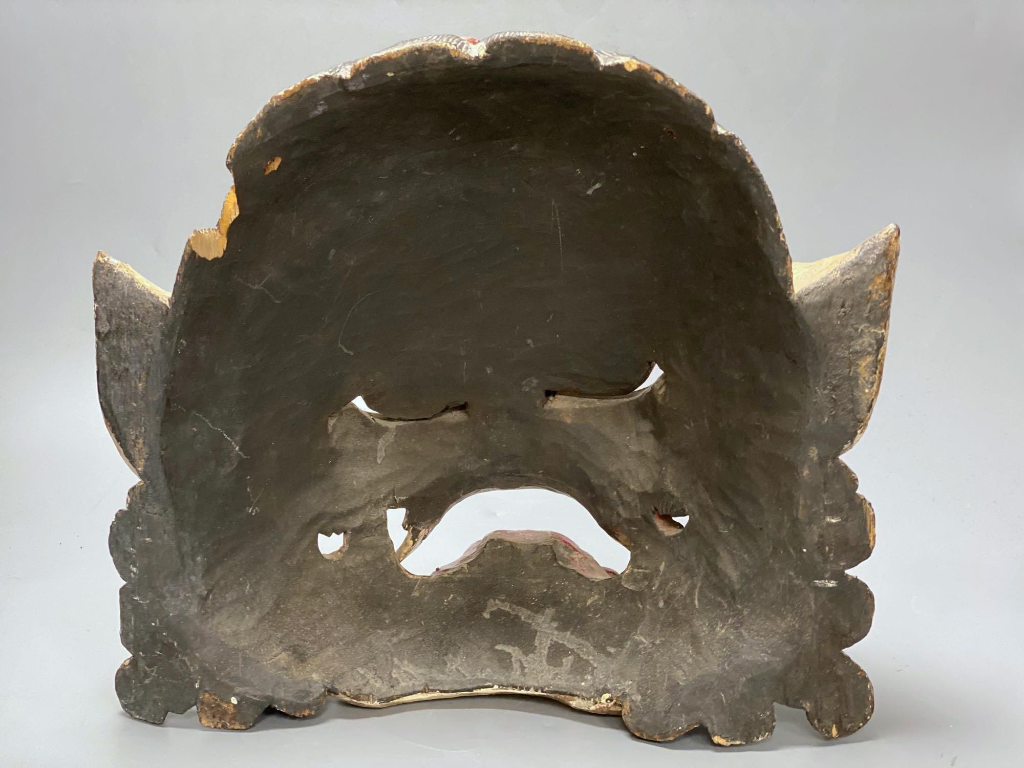 A Balinese carved and painted wood dragon mask, 28cm